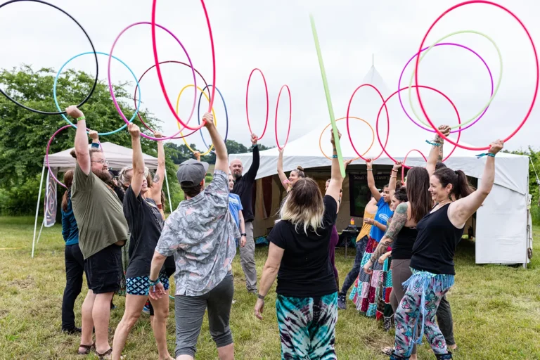 group of people outside with hula hoops