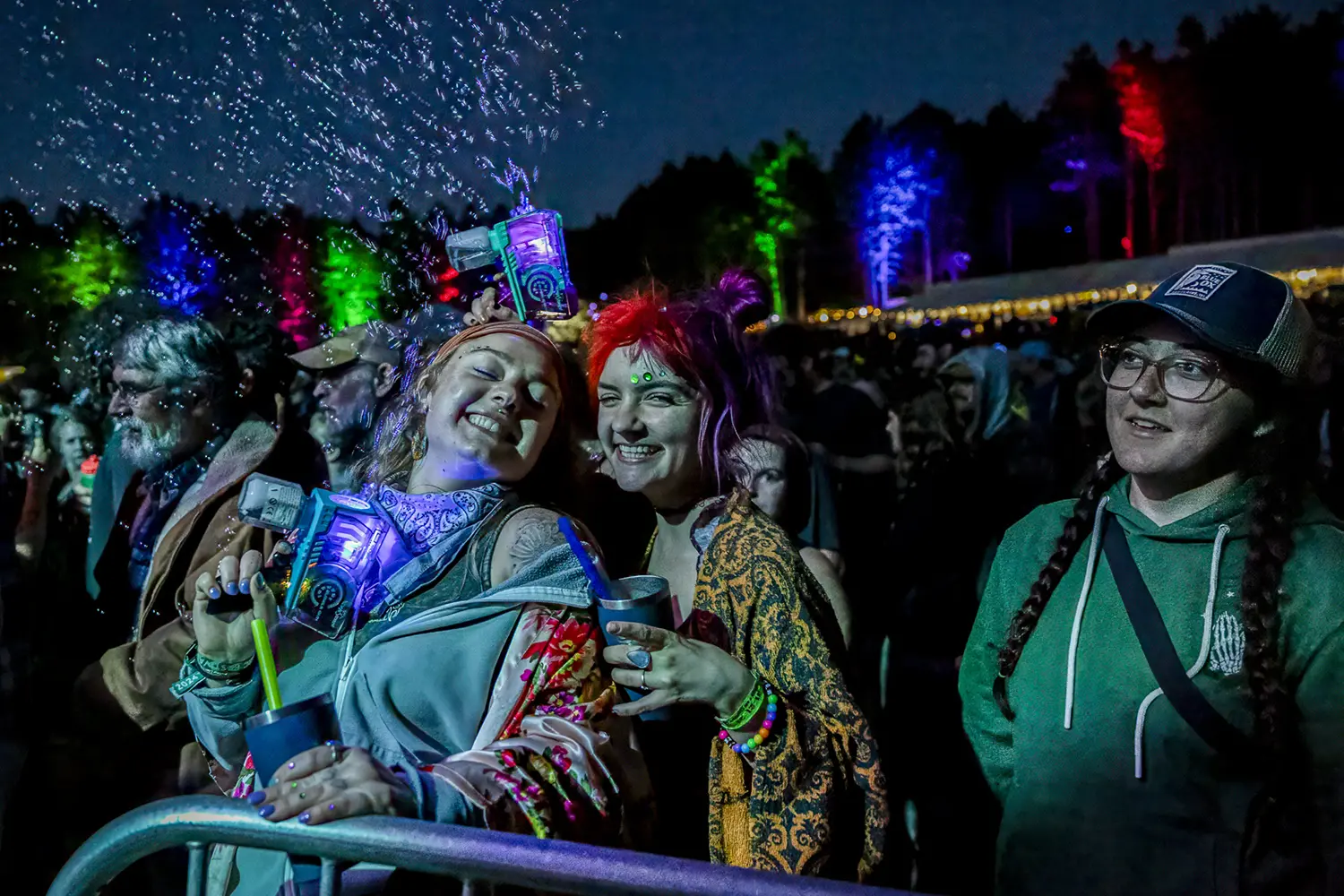 smiling people at night concert