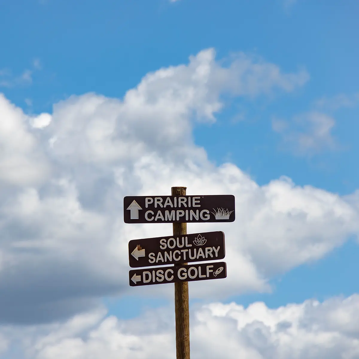 street signs showing way to camping